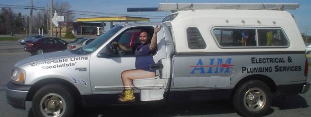 A plumber truck with a toilet painted on the side